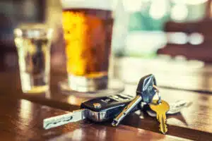 Car keys and glass of beer on table, unfortunately a common recipe for getting arrested and needing a DUI lawyer in Pennsylvania.