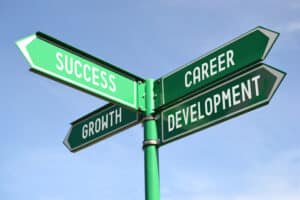 Image of a street sign with multiple directional arrows corresponding to career development choices