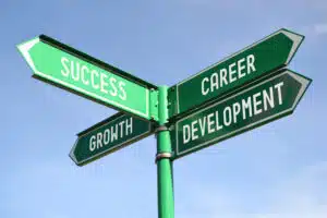 Image of a street sign with multiple directional arrows corresponding to career development choices